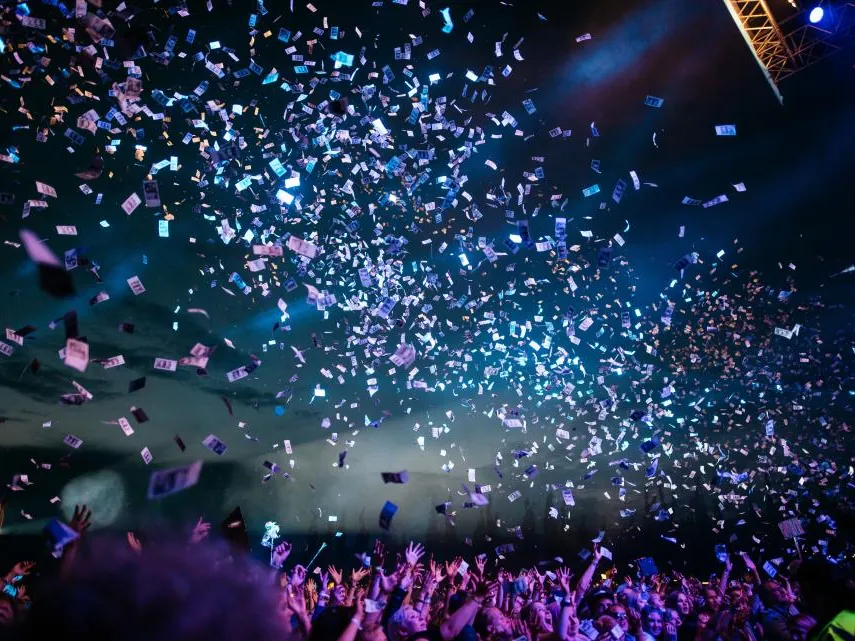 Confetti raining over a cheering crowd
